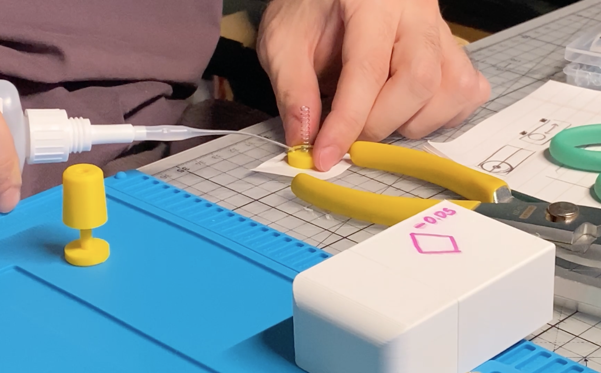 Making of the first working button-like object. Thank you spring and glue.