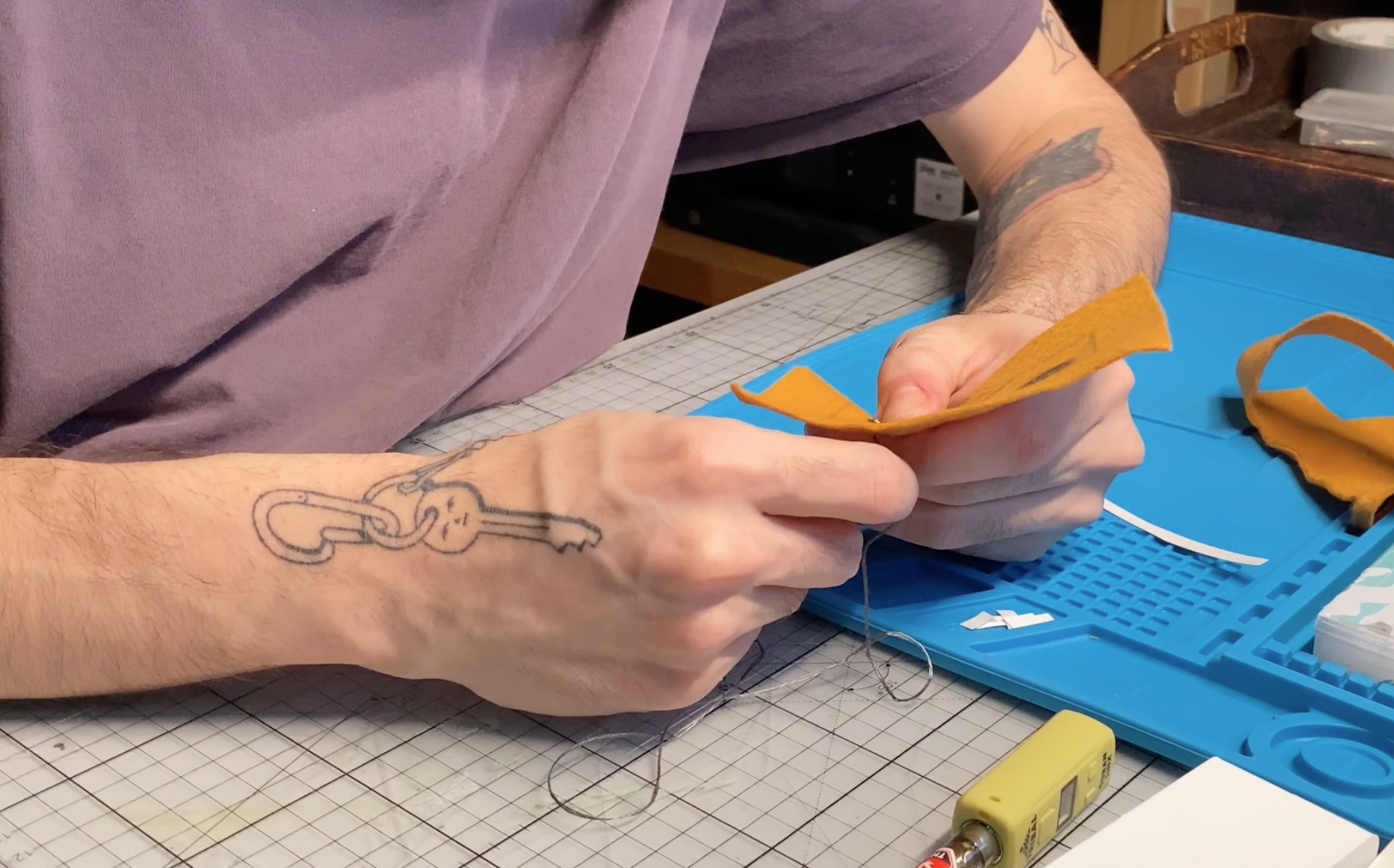 Sewing conductive thread into felt component.