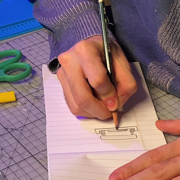 Sketching out ideas for button mechanisms.